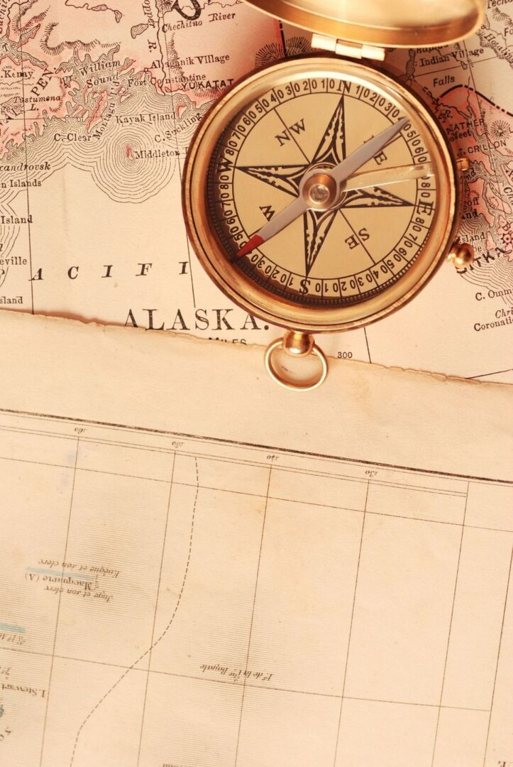 A compass on top of an old map.