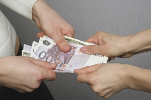 A group of people holding money in their hands.